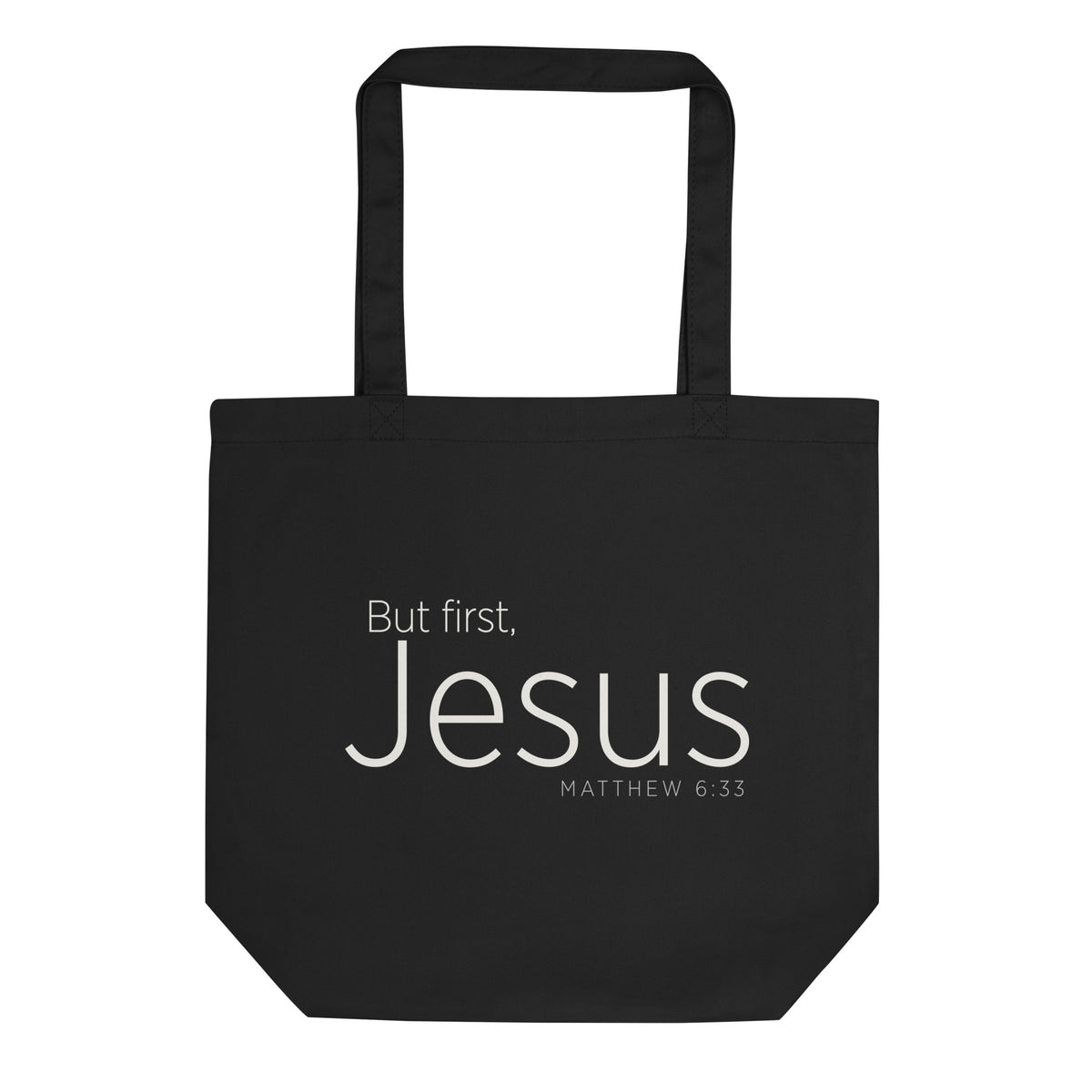 "But first, Jesus Matthew 6:33" in cream white lettering on a black Eco tote bag