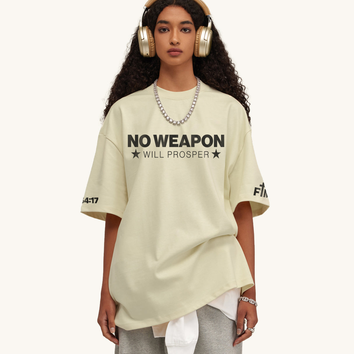 Woman wearing white shirt with "NO WEAPON WILL PROSPER" in black typography. White background.