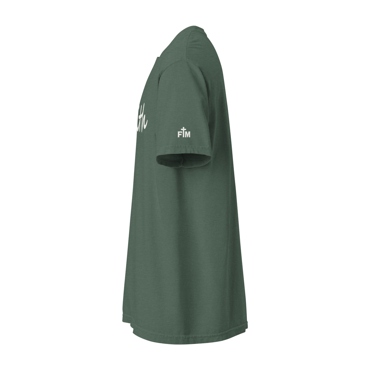 A dark green short-sleeve t-shirt shown from a side profile view against a plain white background. The shirt features white script lettering on the upper chest and a small white 'FM' (Faith Mode) logo on the left sleeve.