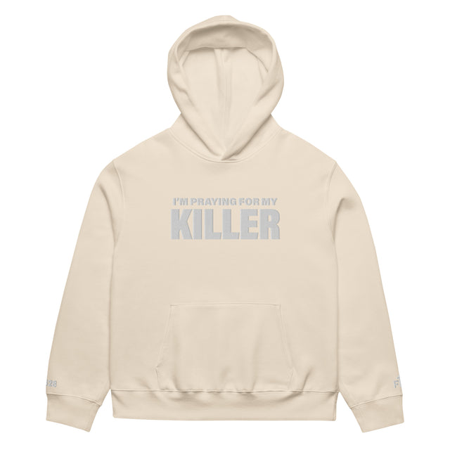 Beige hoodie with text 'I'm Praying for My Killer' on a white background
