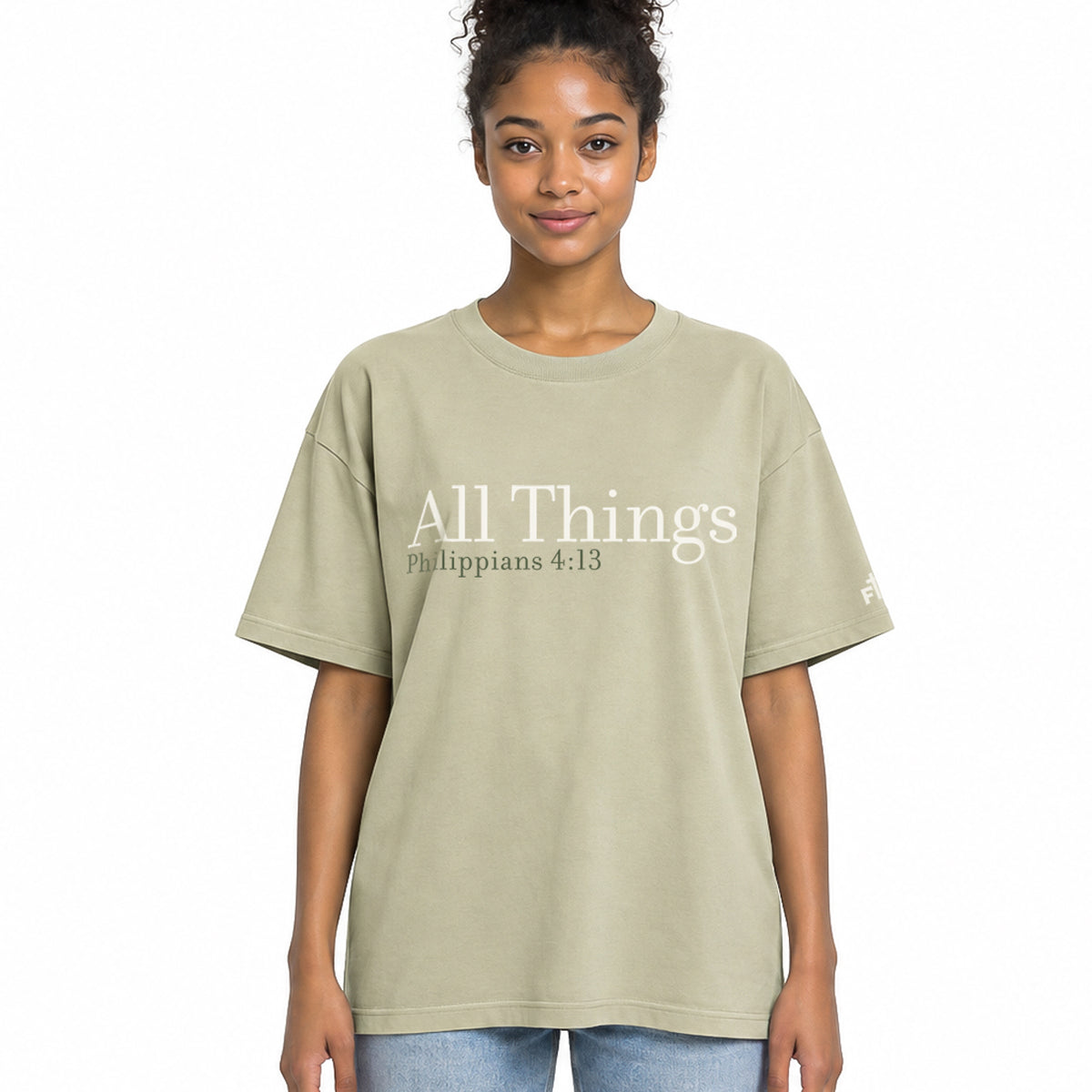 Front view of a Faded Eucalyptus oversized tee featuring cream All Things lettering, Philippians 4:13 beneath it, and a small Faith Mode logo on the left sleeve.