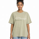 Front view of a Faded Eucalyptus oversized tee featuring cream All Things lettering, Philippians 4:13 beneath it, and a small Faith Mode logo on the left sleeve.