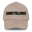 A beige baseball cap with the word 'CHRIST FOLLOWER' embroidered in bold black letters across the front, shown against a plain white background.