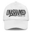 A white baseball cap with black embroidered text reading 'UNASHAMED' and 'ROMANS 1:16' on the front, shown against a plain white background.