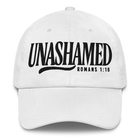 A white baseball cap with black embroidered text reading 'UNASHAMED' and 'ROMANS 1:16' on the front, shown against a plain white background.