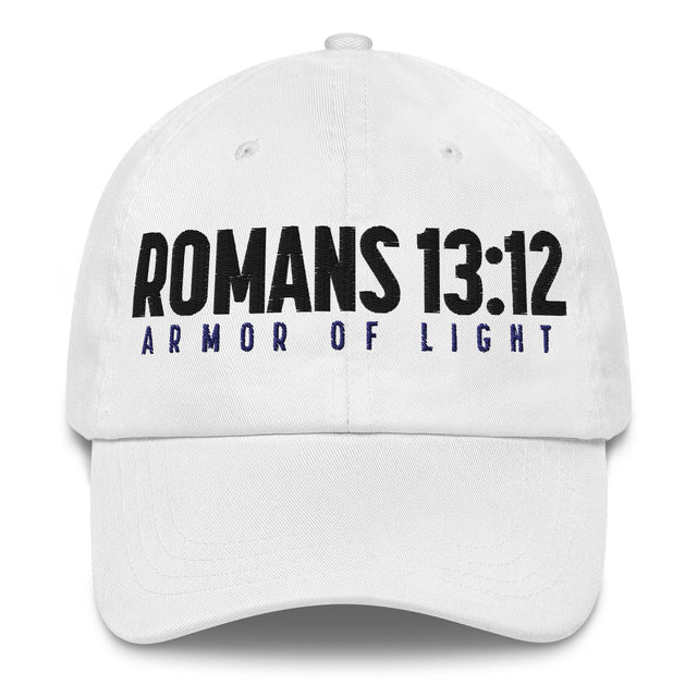 A white baseball cap featuring the text 'ROMANS 13:12' in bold black letters and 'ARMOR OF LIGHT' in dark blue below it, shown against a plain white background.