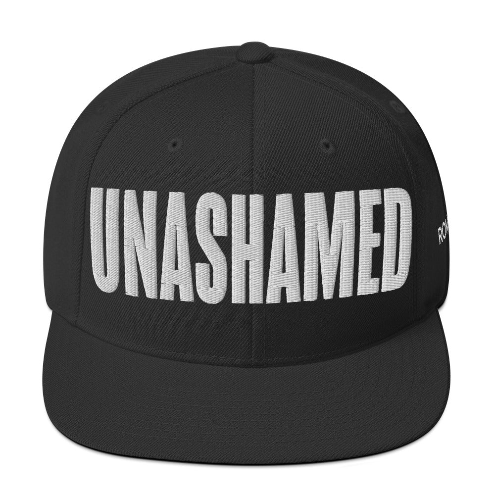 Black cap with 'UNASHAMED' text on a white background