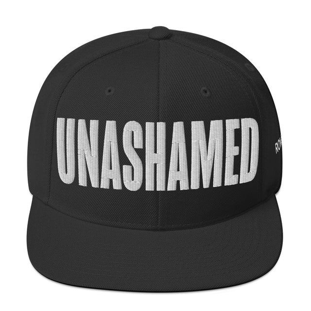 Black cap with 'UNASHAMED' text on a white background