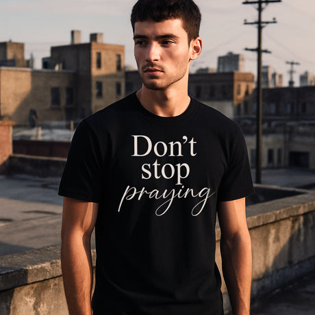 Man Wears Faith Mode's Black Don't Stop Praying Ringspun Cotton Unisex Crewneck Shirt