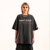 Person wearing a dark gray t-shirt with 'DON'T STOP PRAYING' text on a white background