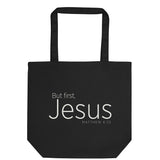 "But first, Jesus Matthew 6:33" in cream white lettering on a black Eco tote bag, flat view