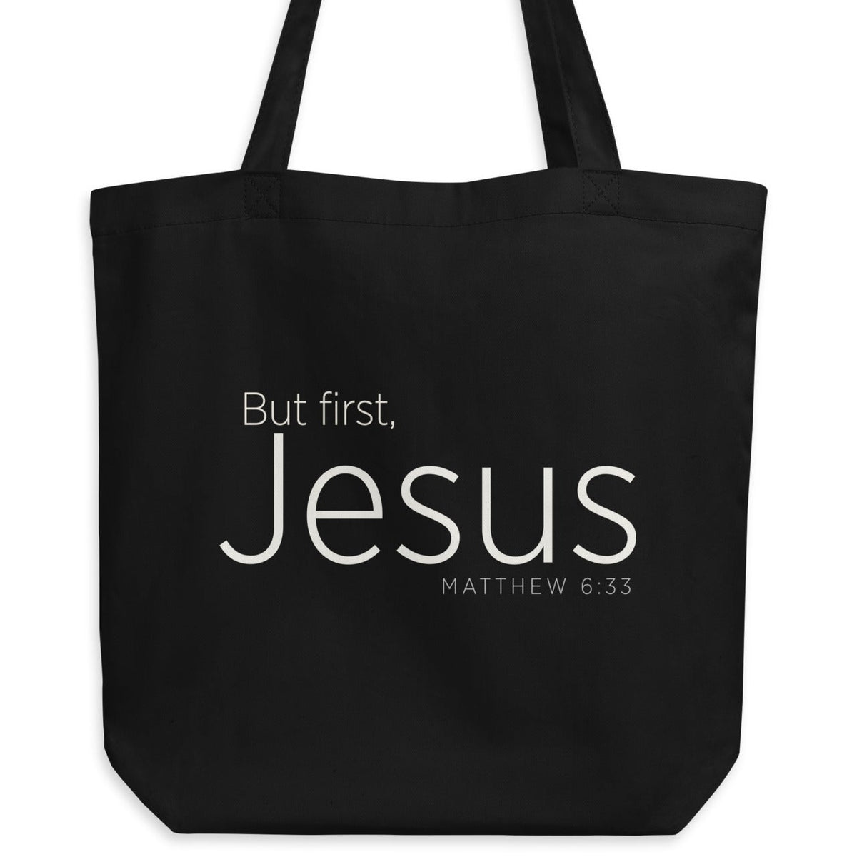 "But first, Jesus Matthew 6:33" in cream white lettering on a black Eco tote bag