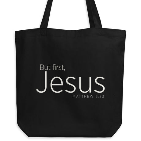 "But first, Jesus Matthew 6:33" in cream white lettering on a black Eco tote bag
