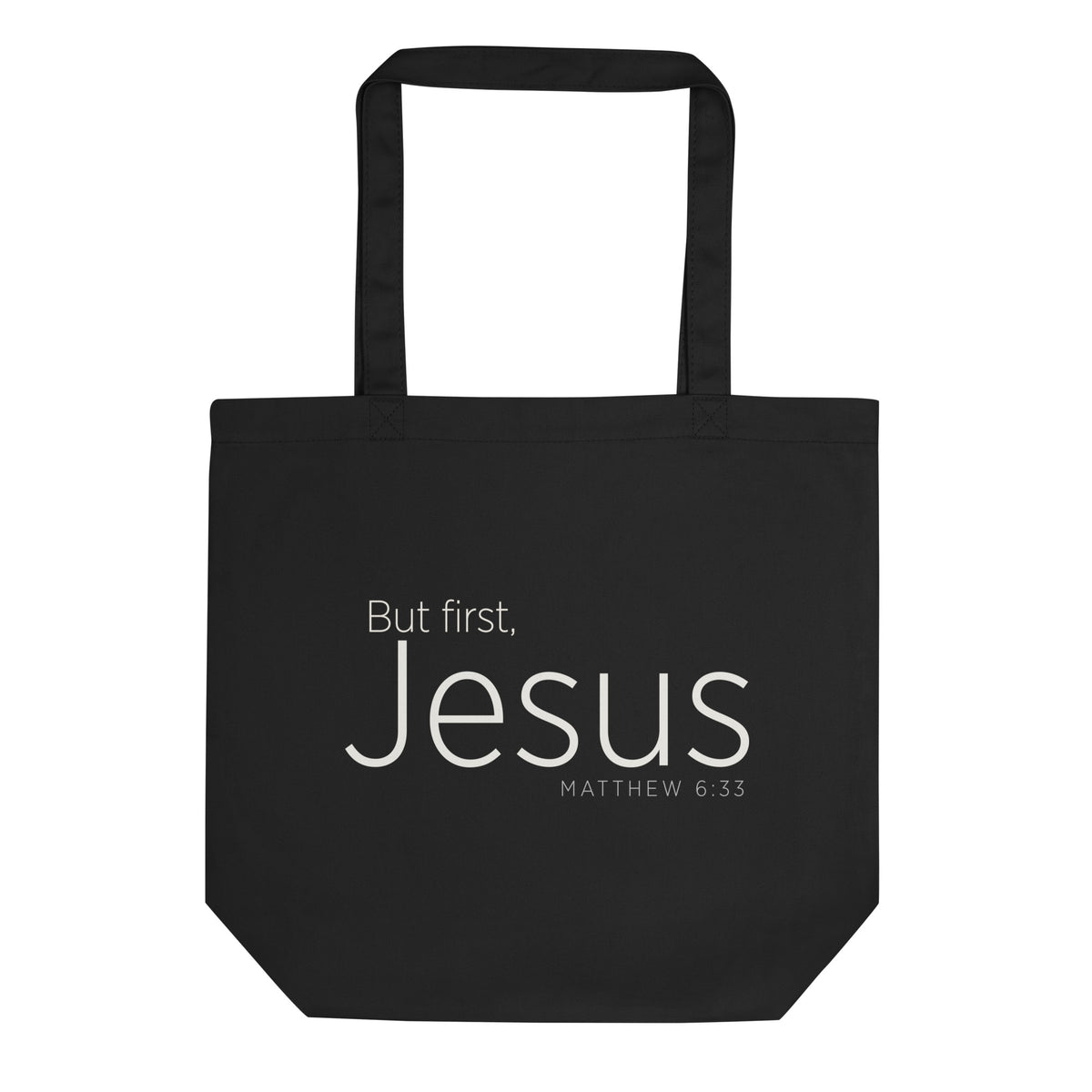 "But first, Jesus Matthew 6:33" in cream white lettering on a black Eco tote bag