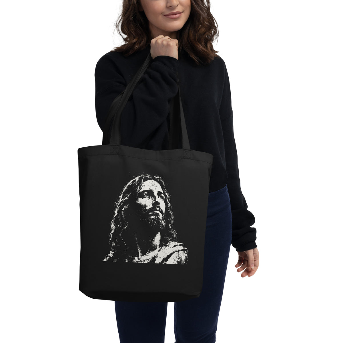 Black eco tote bag featuring a distressed cream-white artistic portrait of Jesus looking upward.