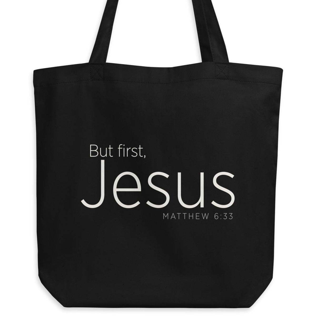 "But first, Jesus Matthew 6:33" in cream white lettering on a black Eco tote bag