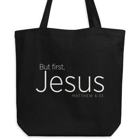 "But first, Jesus Matthew 6:33" in cream white lettering on a black Eco tote bag