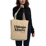 Natural oyster-colored eco tote bag featuring a black Things Above Colossians 3:2 typographic design.