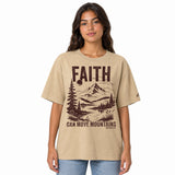 Front view of a Faded Khaki oversized tee featuring deep plum Faith Can Move Mountains lettering, a mountain and lake illustration, Matthew 17:20, and a small sleeve logo.