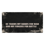 Large gaming mouse pad, black with cream distressing showing the scripture "He trains my hands for war and my fingers for battle, Psalm 144:1"