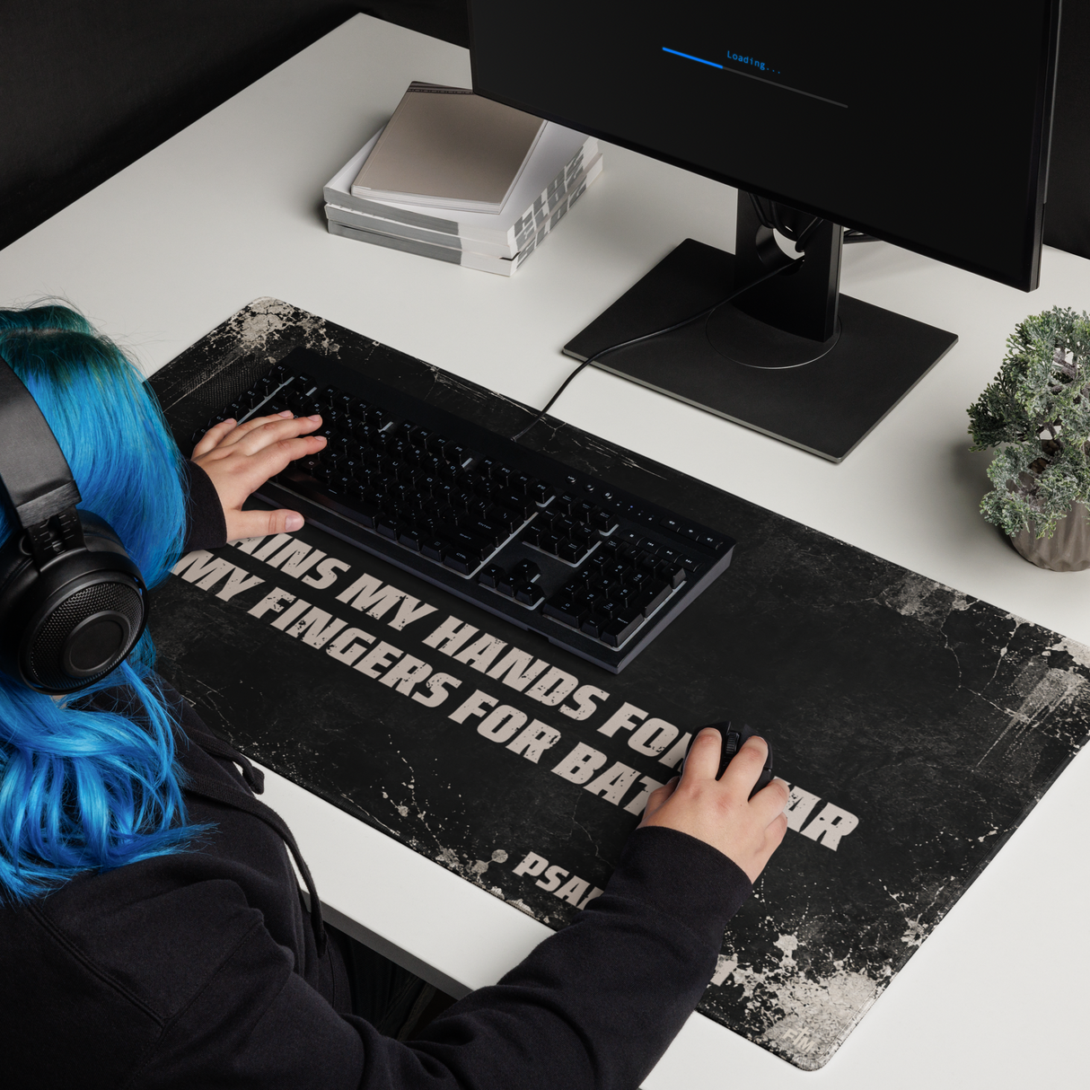 Large gaming mouse pad, black with cream distressing showing the scripture "He trains my hands for war and my fingers for battle, Psalm 144:1"