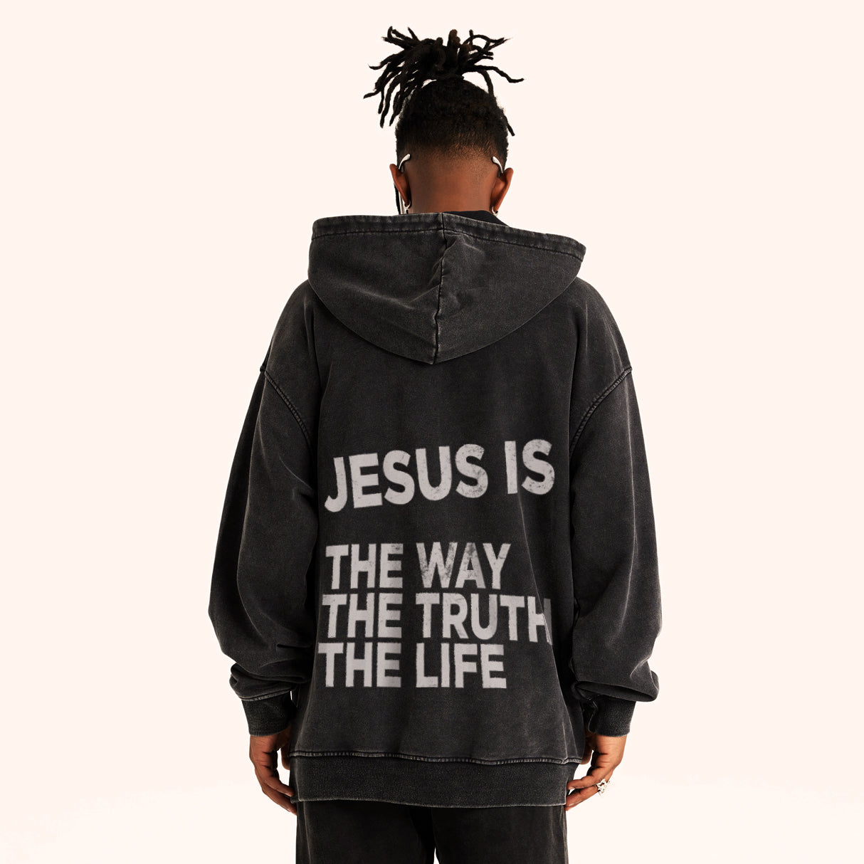 Man wearing super heavyweight black retro Faith Mode hoodie with "JESUS IS THE WAY THE TRUTH THE LIFE" in white ink. White backdrop.