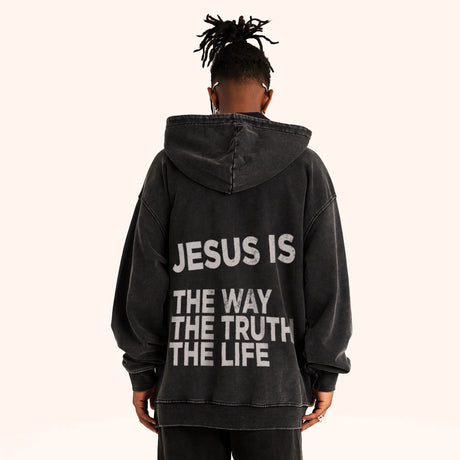Man wearing super heavyweight black retro Faith Mode hoodie with "JESUS IS THE WAY THE TRUTH THE LIFE" in white ink. White backdrop.