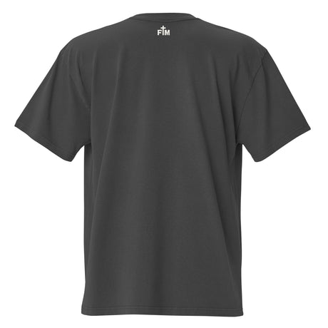 Small cream white "FM" Faith Mode logo printed on the upper back neck of a faded-black oversized tee 