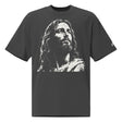 Front view of a faded-black oversized tee featuring a distressed cream artistic portrayal of Jesus and a small Faith Mode logo on the left sleeve.