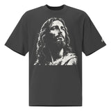 Front view of a faded-black oversized tee featuring a distressed cream artistic portrayal of Jesus and a small Faith Mode logo on the left sleeve.