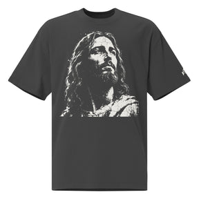 Front view of a faded-black oversized tee featuring a distressed cream artistic portrayal of Jesus and a small Faith Mode logo on the left sleeve.