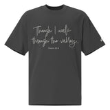 Front view of a Faded Black oversized tee featuring Though I Walk Through the Valley in cream script, Psalm 23:4, and a small Faith Mode sleeve logo.
