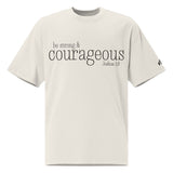 Front view of a faded bone oversized tee featuring black Be Strong & Courageous lettering, Joshua 1:9, and a small Faith Mode logo on the left sleeve.