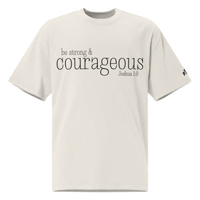 Front view of a faded bone oversized tee featuring black Be Strong & Courageous lettering, Joshua 1:9, and a small Faith Mode logo on the left sleeve.