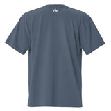 Small cream white "FM" Faith Mode logo printed on the upper back neck of a faded-indigo oversized tee