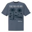 Front view of a Faded Indigo oversized tee featuring The Sea Is His, Psalm 95:5, palm trees, a surfboard, sun, ocean waves, and a small sleeve logo.