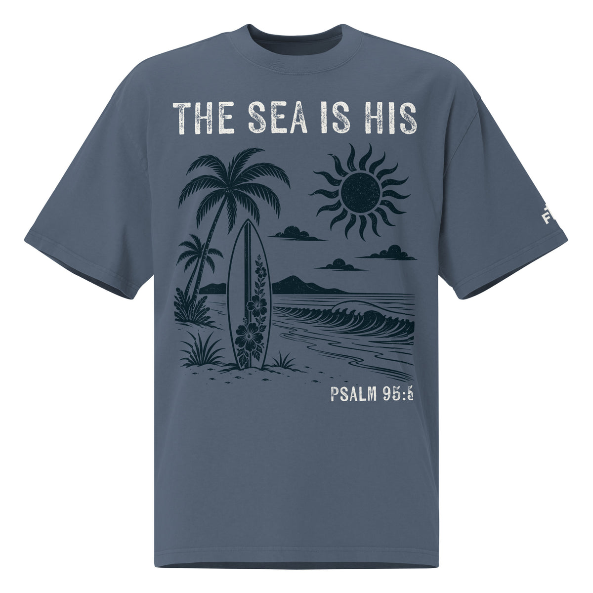 Front view of a Faded Indigo oversized tee featuring The Sea Is His, Psalm 95:5, palm trees, a surfboard, sun, ocean waves, and a small sleeve logo.