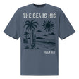 Front view of a Faded Indigo oversized tee featuring The Sea Is His, Psalm 95:5, palm trees, a surfboard, sun, ocean waves