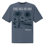 Front view of a Faded Indigo oversized tee featuring The Sea Is His, Psalm 95:5, palm trees, a surfboard, sun, ocean waves