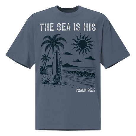 Front view of a Faded Indigo oversized tee featuring The Sea Is His, Psalm 95:5, palm trees, a surfboard, sun, ocean waves
