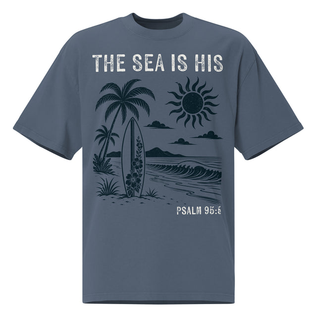 Front view of a Faded Indigo oversized tee featuring The Sea Is His, Psalm 95:5, palm trees, a surfboard, sun, ocean waves