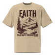 Front view of a Faded Khaki oversized tee featuring deep plum Faith Can Move Mountains lettering, a mountain and lake illustration, Matthew 17:20, and a small sleeve logo.