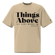 Front view of a Faded Khaki oversized tee featuring black Things Above and Set Your Minds On lettering, Colossians 3:2, and a small Faith Mode sleeve logo.