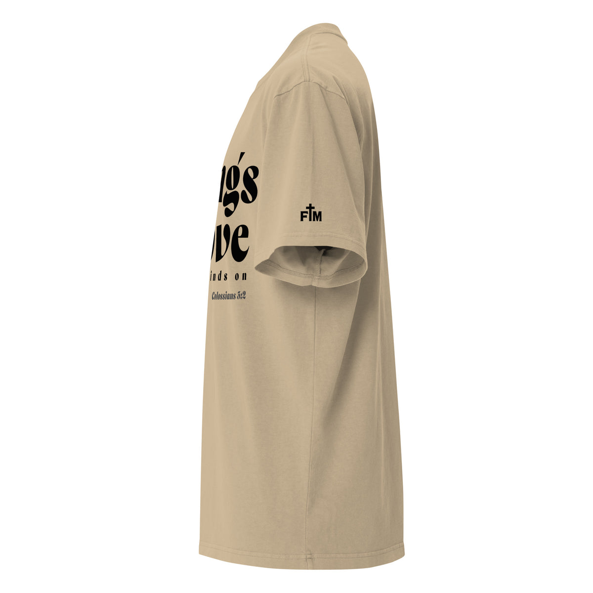 Side view of a Faded Khaki oversized tee featuring black Things Above and Set Your Minds On lettering, Colossians 3:2, and a small Faith Mode sleeve logo.