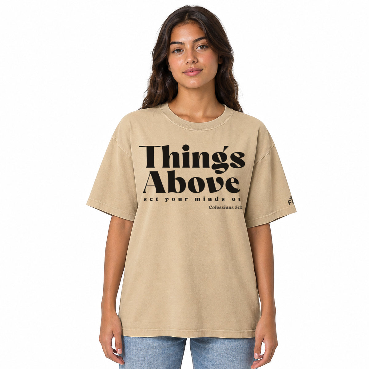 Front view of a Faded Khaki oversized tee featuring black Things Above and Set Your Minds On lettering, Colossians 3:2, and a small Faith Mode sleeve logo.