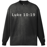 Black long-sleeve shirt with 'Luke 10:19' printed on a white background