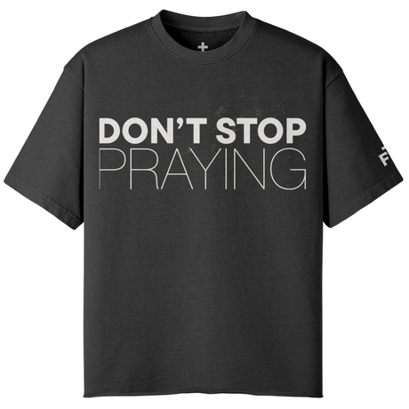 Black t-shirt with 'DON'T STOP PRAYING' text on a white background