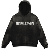 Black hoodie with "ROM. 12:19" in white typography printed on the front.