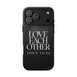 A black protective phone case featuring the text 'LOVE EACH OTHER JOHN 13:34' in a distressed white serif font, shown on a plain white background.