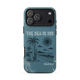 A protective phone case with a distressed blue ocean-themed graphic featuring palm trees, a surfboard, a sun, and the text 'THE SEA IS HIS' and 'PSALM 95:5'.